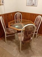 Full dining set in corner showing table and four chairs