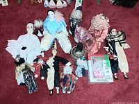 Group shot of all porcelain clown and harlequin dolls, boxed kit and trinket box