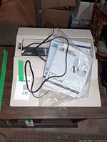 Top view of Smith Corona word processor with manual and cord on lid