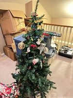 Full view of artificial Christmas tree with decorations