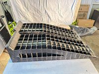 Black plastic ramps side view showing grid tread and stop