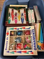 Overview of boxed ornaments in blue Rubbermaid tote