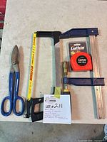 Group shot of all four tools: hacksaw, speed clamp, tin snips, tape measure