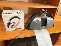 Electra Vortex headphone box beside iMode docking station showing both items