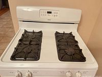 Top view showing four sealed burners with porcelain-coated cast-iron grates and control panel