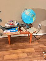 Side table with globe, books, supplies