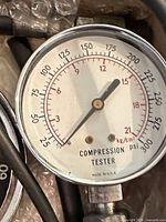 Close-up of compression tester gauge