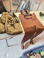 Vest and chest waders laid on table