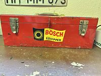 Front view of red Bosch toolbox showing latches and decal