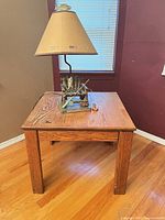 Lamp on top of square oak end table