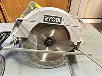 Left side view showing Ryobi branding and 7-1/4 in blade