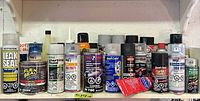 Full shelf view of assorted aerosol cans