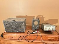 All three instruments on dresser: Jerrold meter, Heathkit T-4, HP 3311A