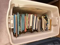Storage bin filled with upright children’s books