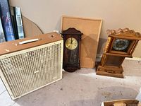 Group shot showing fan, two clocks, corkboard