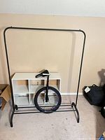 Overall shot of garment rack, shelf unit and unicycle