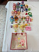 Full lot laid out: dolls, pets, accessories, tote, wallet