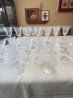 Group shot of entire 32-piece etched stemware set on table