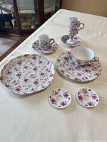 Group shot of all nine Lefton pink rose pieces laid out