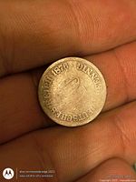 Reverse side showing inscription "DEUTSCHES REICH 1876" around worn central area