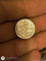 Reverse of 1927 Canadian 5-cent coin showing denomination, maple leaves and date