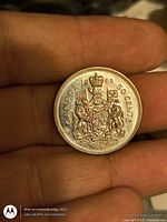 Reverse of 1968 Canadian 50-cent coin showing Canadian Coat of Arms and date