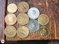 Group shot of all ten tokens laid out on wood surface
