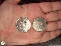 Both coins front side: Jamaica coat of arms on decagon coin, Barbados coat of arms on round coin