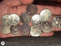 Group of Canadian 50-cent coins showing obverse and reverse designs