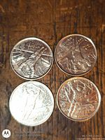 Four ice hockey 25-cent coins on wooden surface