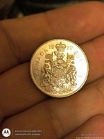 Reverse side showing Canadian Coat of Arms and 50 CENTS inscription