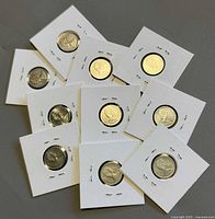 Group shot of ten Canadian 10-cent coins in flips