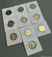 Full view of 9 of the 10 stapled flips laid out showing obverse and reverse mix