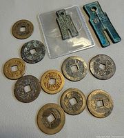Group shot showing all ten cash coins and two spade coins, one in sleeve