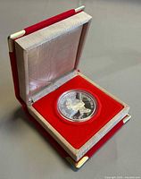 Coin in red clamshell case