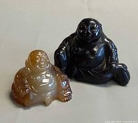 Both Buddha figurines side by side