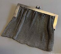 Front view of silver mesh purse showing frame and mesh body