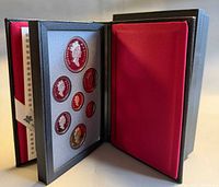 Case open showing mounted coins and red interior sleeve