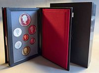 Open leatherette case showing obverse of all seven coins