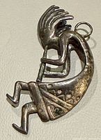 Front view of Kokopelli pendant showing overall design and bail