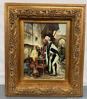 Full view of framed artwork showing ornate gold frame and painting inside