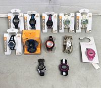 All 12 watches laid out showing packaging and loose pieces