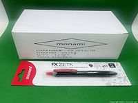 Blister-packed FX Zeta pen in front of 12-count box