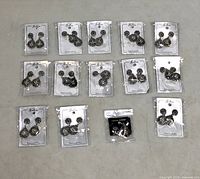 Group view of all 14 packaged pairs of earrings