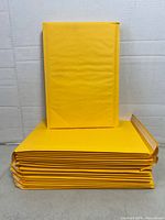 Stack of yellow padded mailers, one propped upright