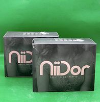 Front view of two sealed Niidor bra boxes