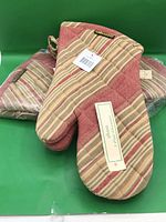 Two pairs of Alkaso striped oven mitts, one wrapped in plastic