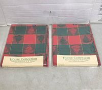 Both packaged tablecloths front view showing brand, pattern and size