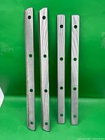 Four blades shown upright against green background