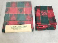 Packaged tablecloth next to folded tea towel showing matching pattern